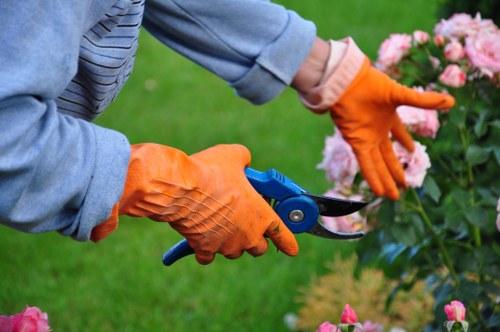 Gardener in high-visibility jacket starting work in a garden
